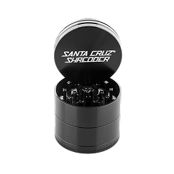 Studio shot of an open, black Santa Cruz Shredder herb grinder.