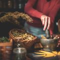 Grinding Dried Cannabis Buds With Mortar and Pestle.